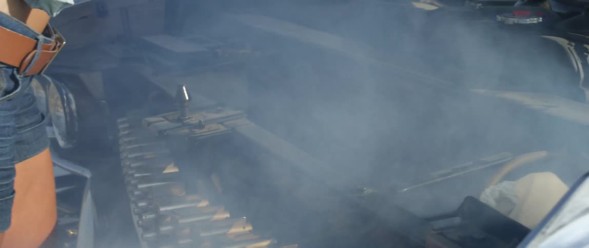 Two women looking at a smoking engine