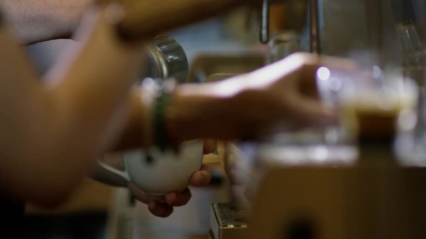 People making drinks at a coffee bar