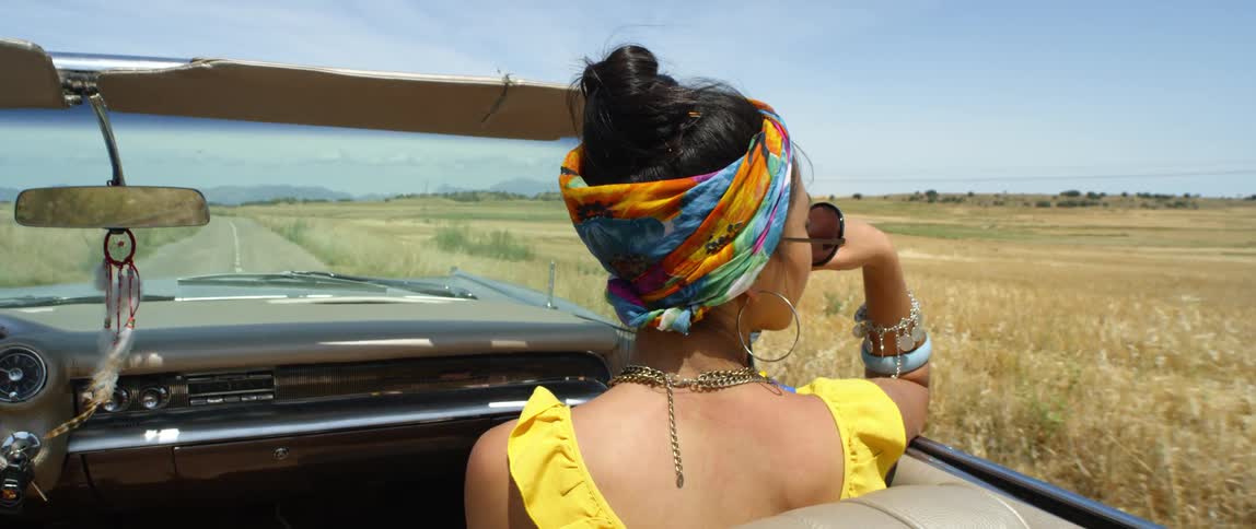 A woman sitting in a driving car