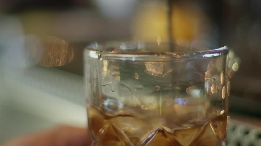 A drink being stirred with a bar spoon