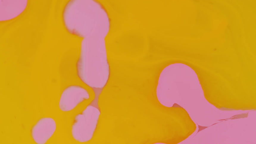 Pink and yellow paint is being mixed together