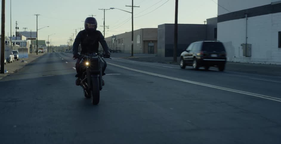A person driving a motorbike in a city