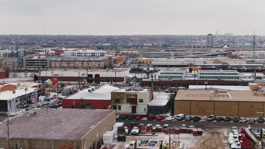 Cars are parked in parking lots in an industrial and business area of a city