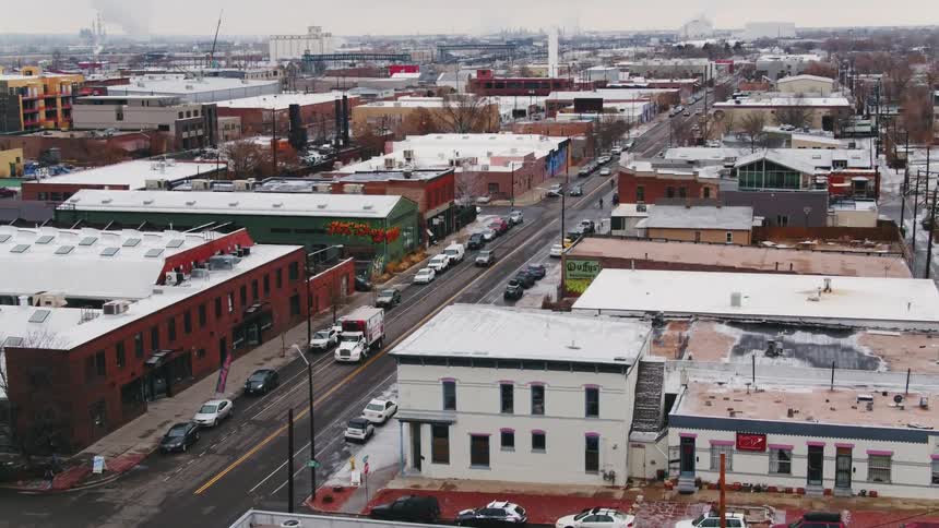 An aerial view of cars driving in a city is displayed