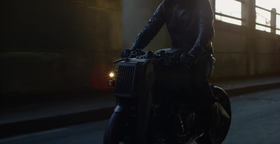 A person on a motorcycle driving down a road
