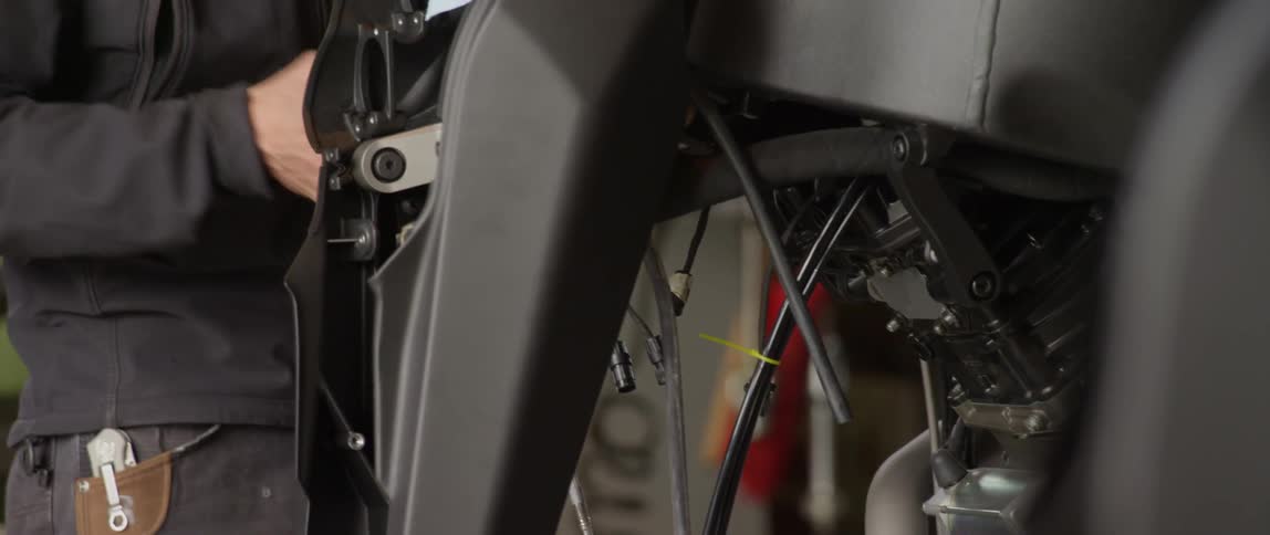 A mechanic works on an automobile