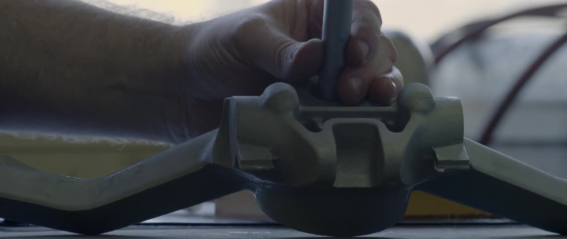 A person is using tools in a shop