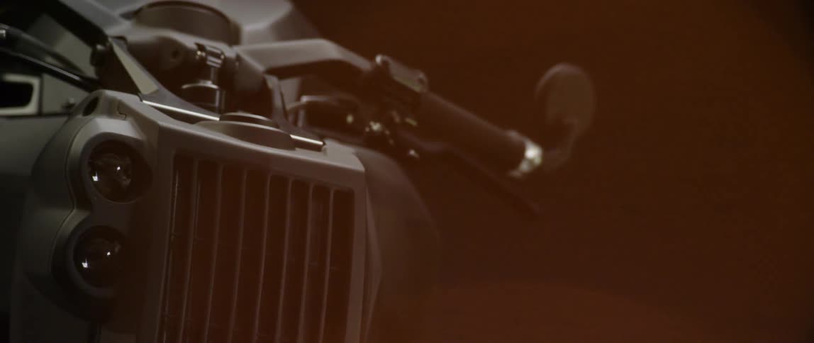 The front of a motorcycle in the darkness