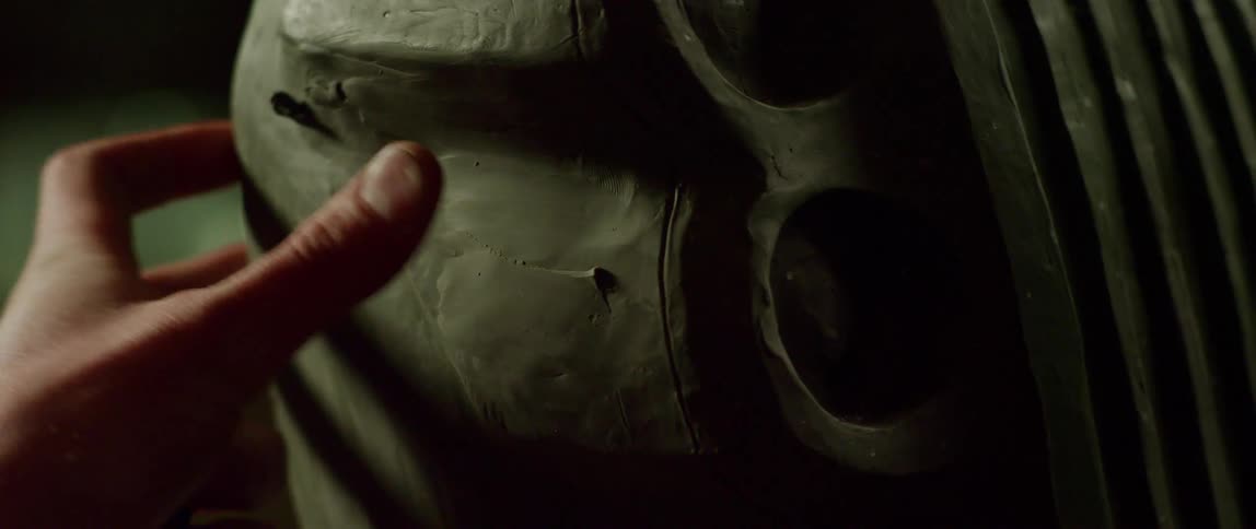 A person using their thumb to smooth clay on a sculpture