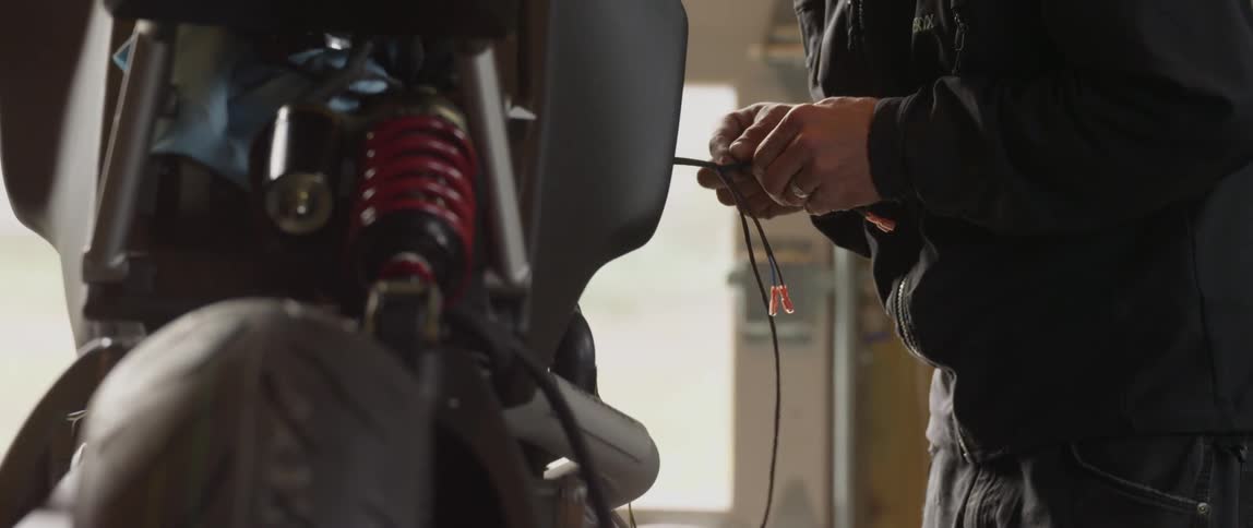 A person working on their motorbike