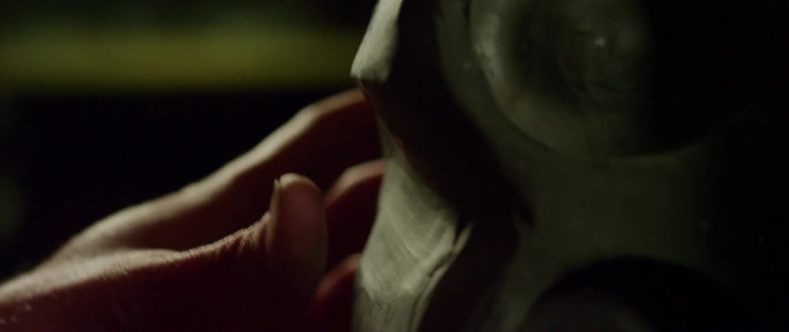 A person touches a wooden object