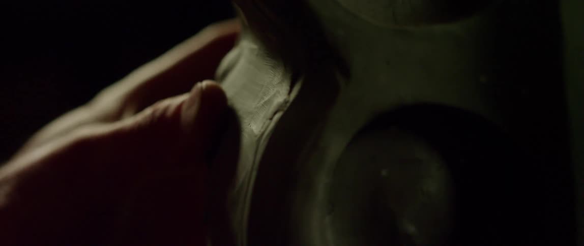 An artist smoothes out the details of a sculpture