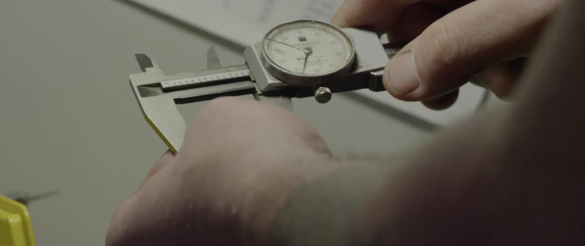 A man uses a handheld measuring tool