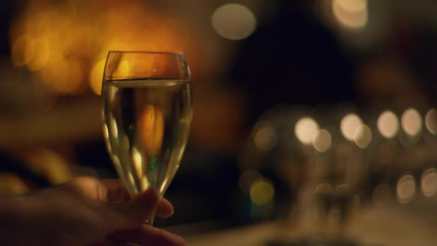 A person moves a glass of wine