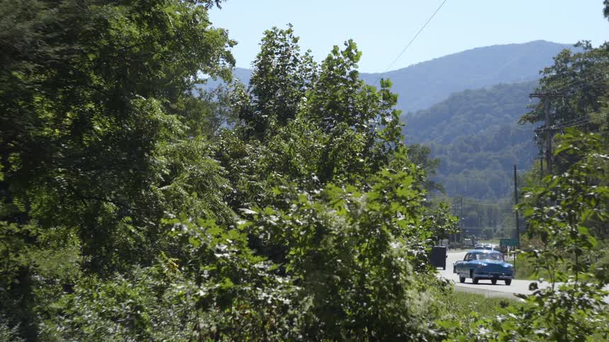 Cars are driving on a road