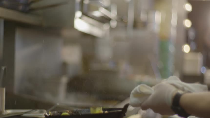 A chef is cooking food in a restaurant