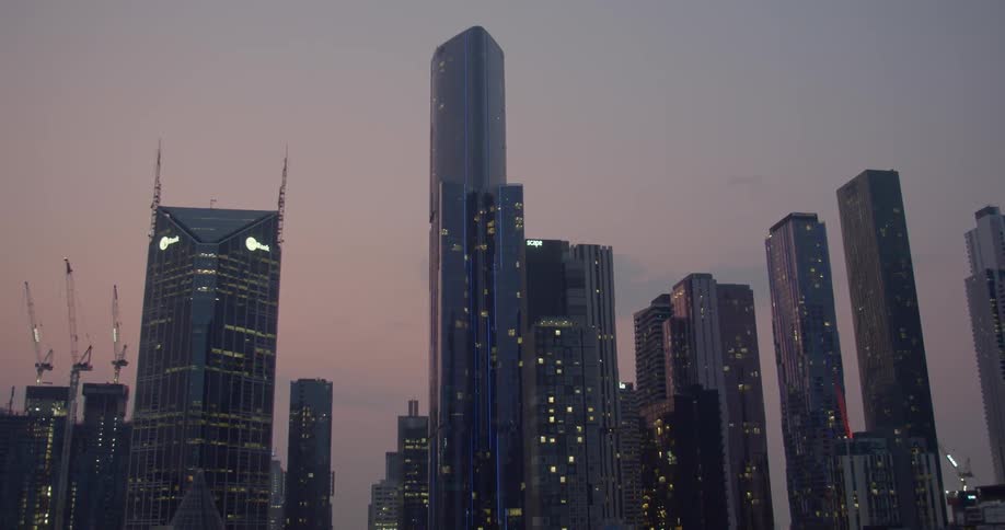 The sun is setting above the skyscrapers