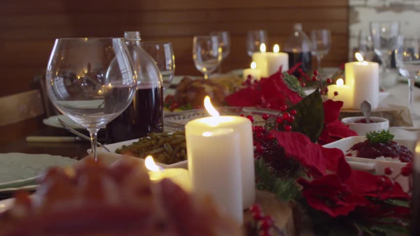 Candles blowing in the wind at a holiday dinner