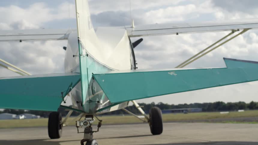 A plane adjusts its wings as it prepares for takeoff