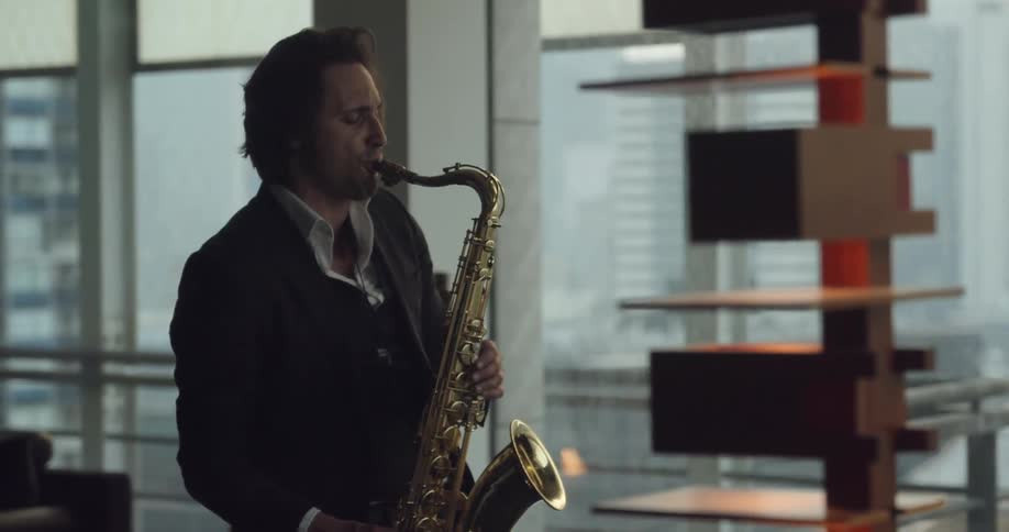 A man is playing the saxophone