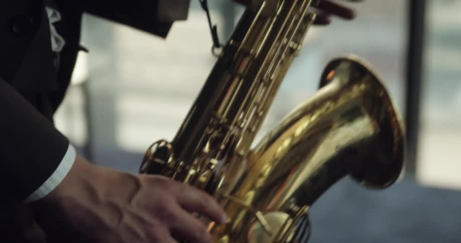 A person plays a saxaphone