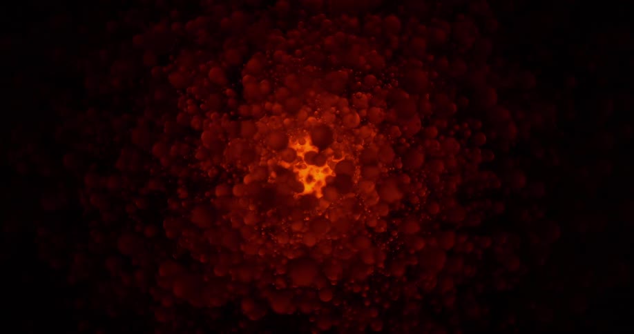Blobs of a red jelly like substance move around a glowing light