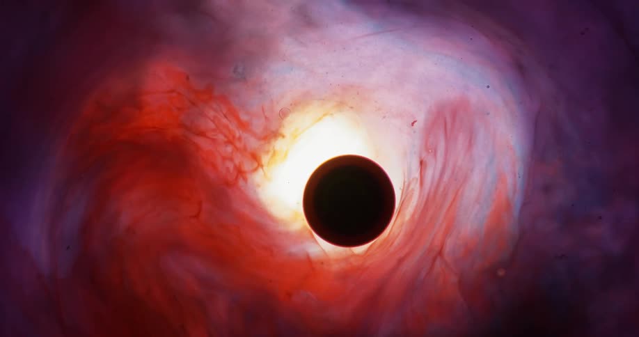 A dark orb is surrounded by slowly moving streaks of various colors