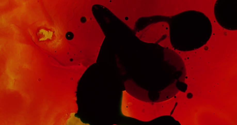 Birds eye view of colored liquids mixing together