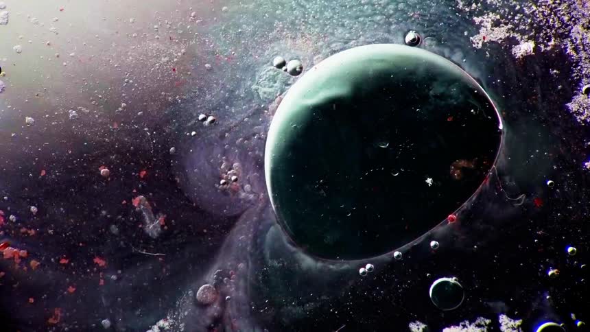 A large green orb has smaller orbs floating around it
