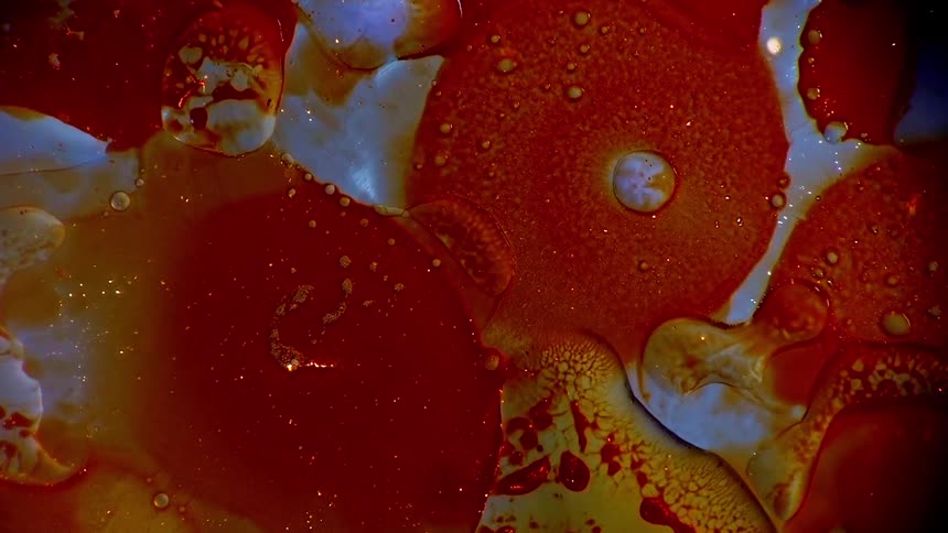 Orange and whites liquids blend and merge