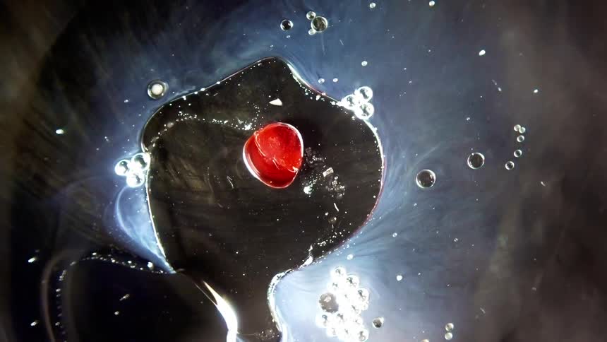 Birds eye view of liquids moving and mixing together