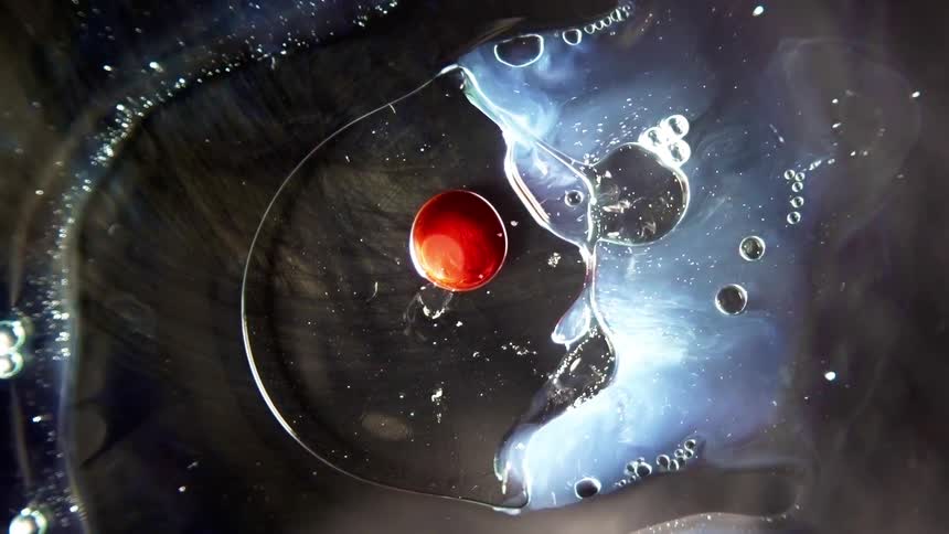 Liquids mixing and bubbling over glass surface