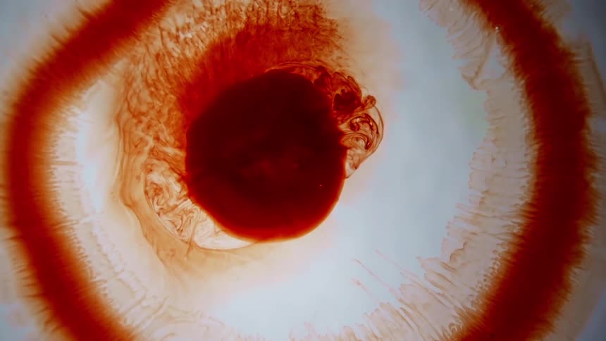 Red liquid moves in a clear fluid