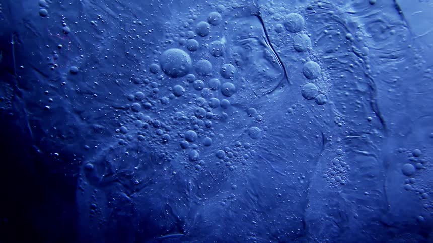 Blue liquid with swirling bubbles