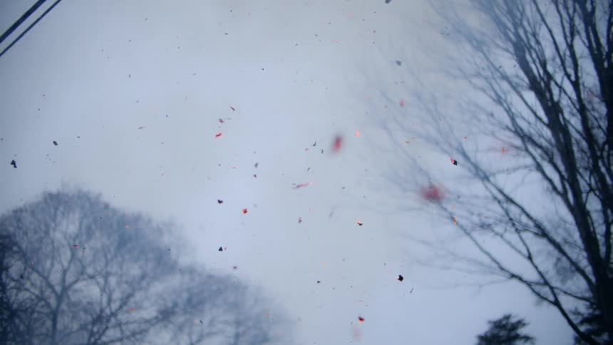 The debris slowly falls towards the ground