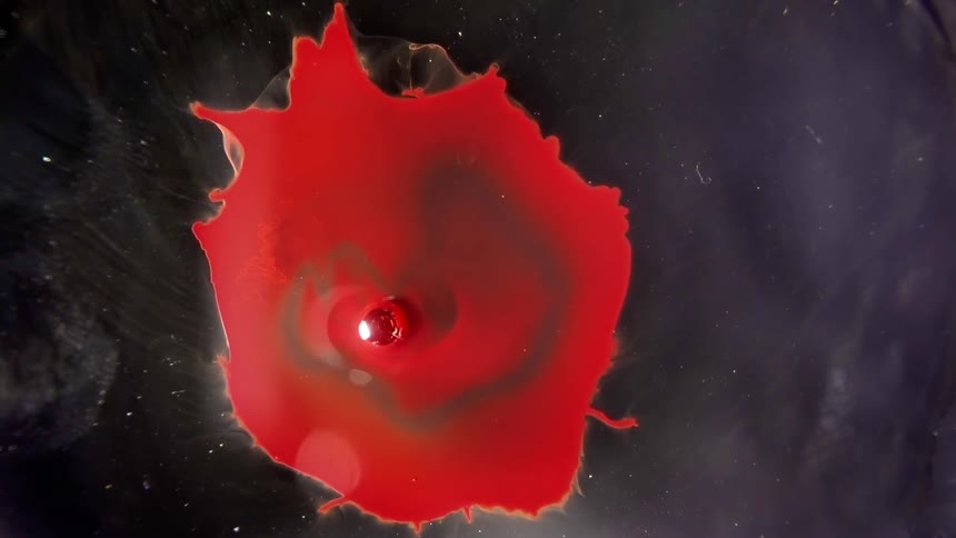 Red liquid emanates from a central source and then is sucked back in