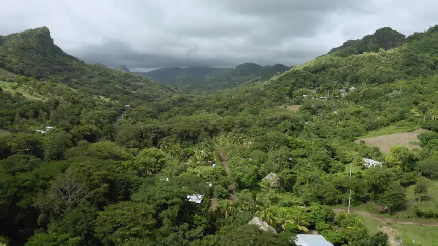 Aerial view of a small town on a dense tropical forest