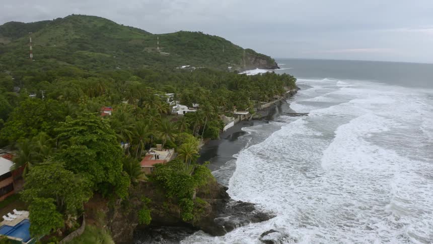 Houses surrounded by the ocean and lush greenery