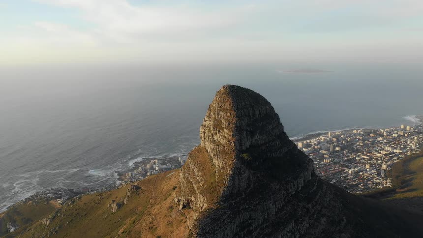 A large rock overlooks the city