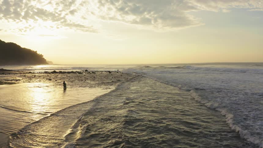 Waves are crashing towards the beach