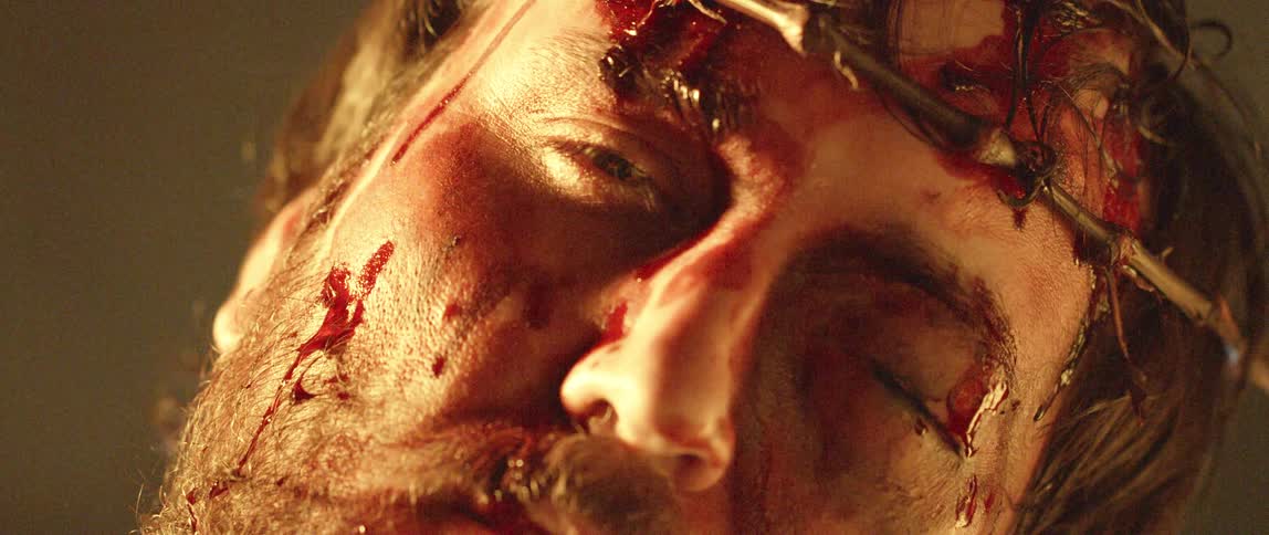 Representation of jesus with bloody face wearing thorn crown
