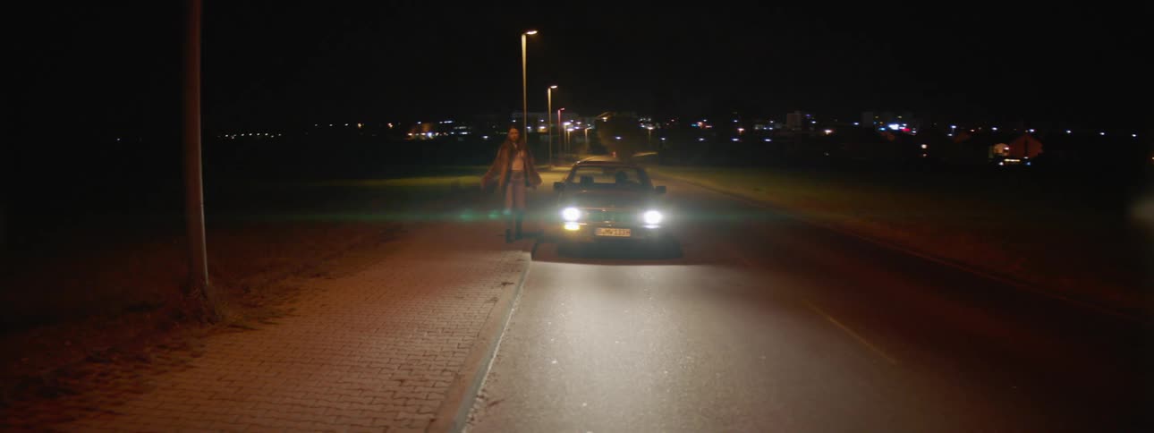 A woman walks away from the car