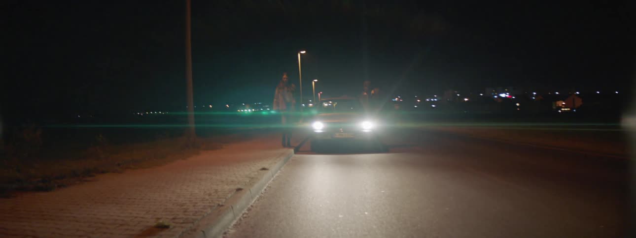 A man and woman get out of a vehicle and the man chases the woman and grabs her