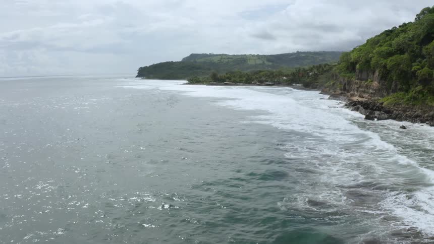 Ocean waves wash ashore along a very rocky coastline