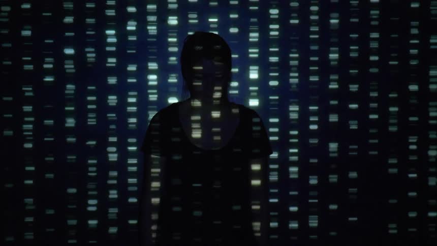 A person stands in a room filled with flashing lights