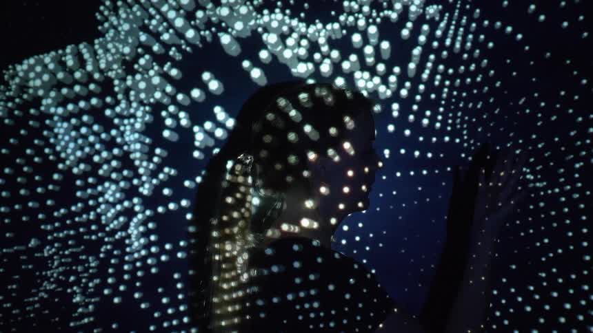 A digital display of lights on the silhouette of a woman