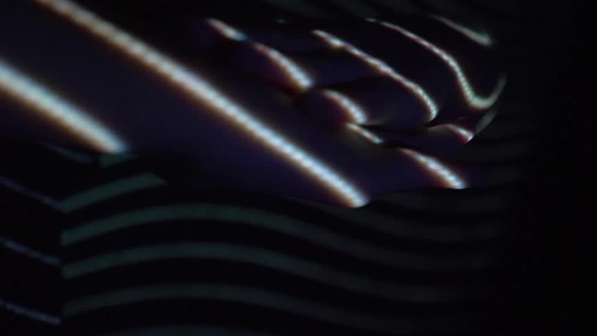 Lights reflect on a womans hand
