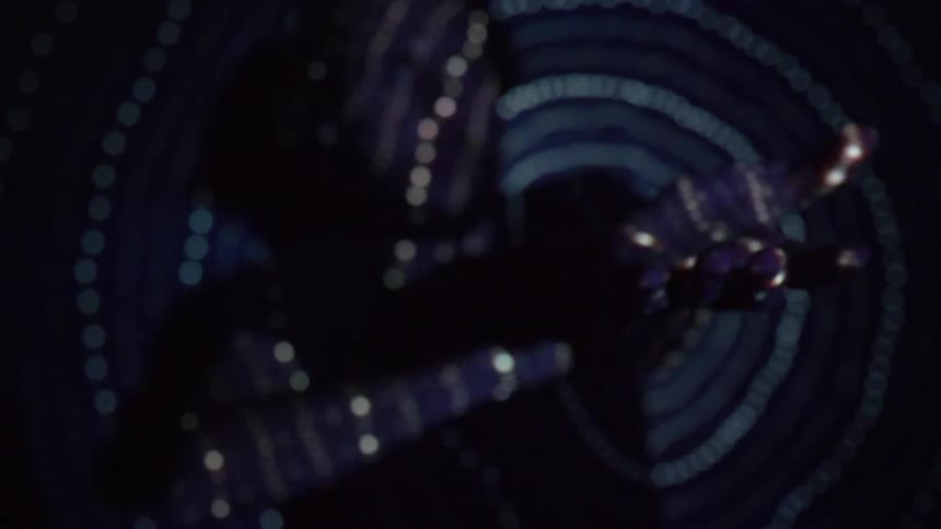 Man reaching out while bathed in a light pattern