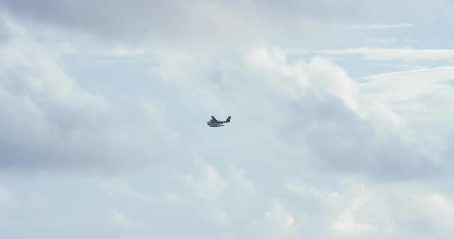 Small aircraft flying surrounded by clouds