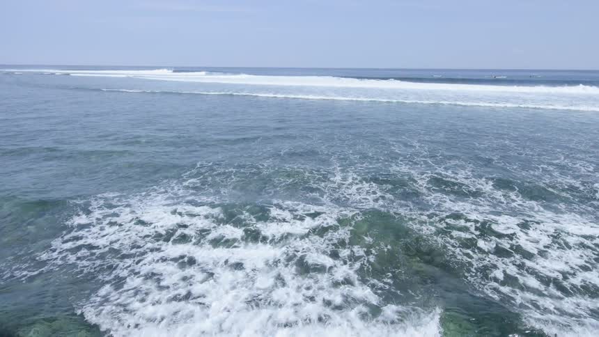 The beach with waves and the sky in the background